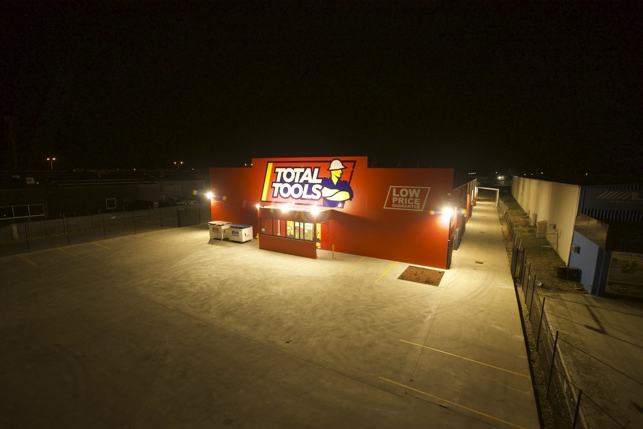 Total Tools store exterior at night showing commercial exterior lighting installed by EDN